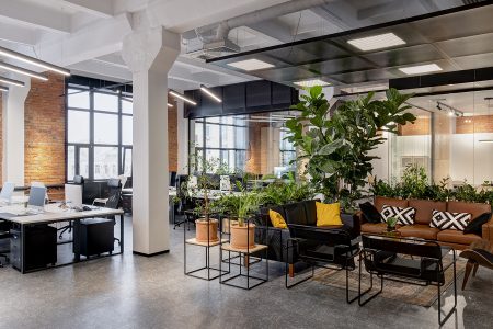 modern loft office interior with panoramic windows and a row of dark wood tables